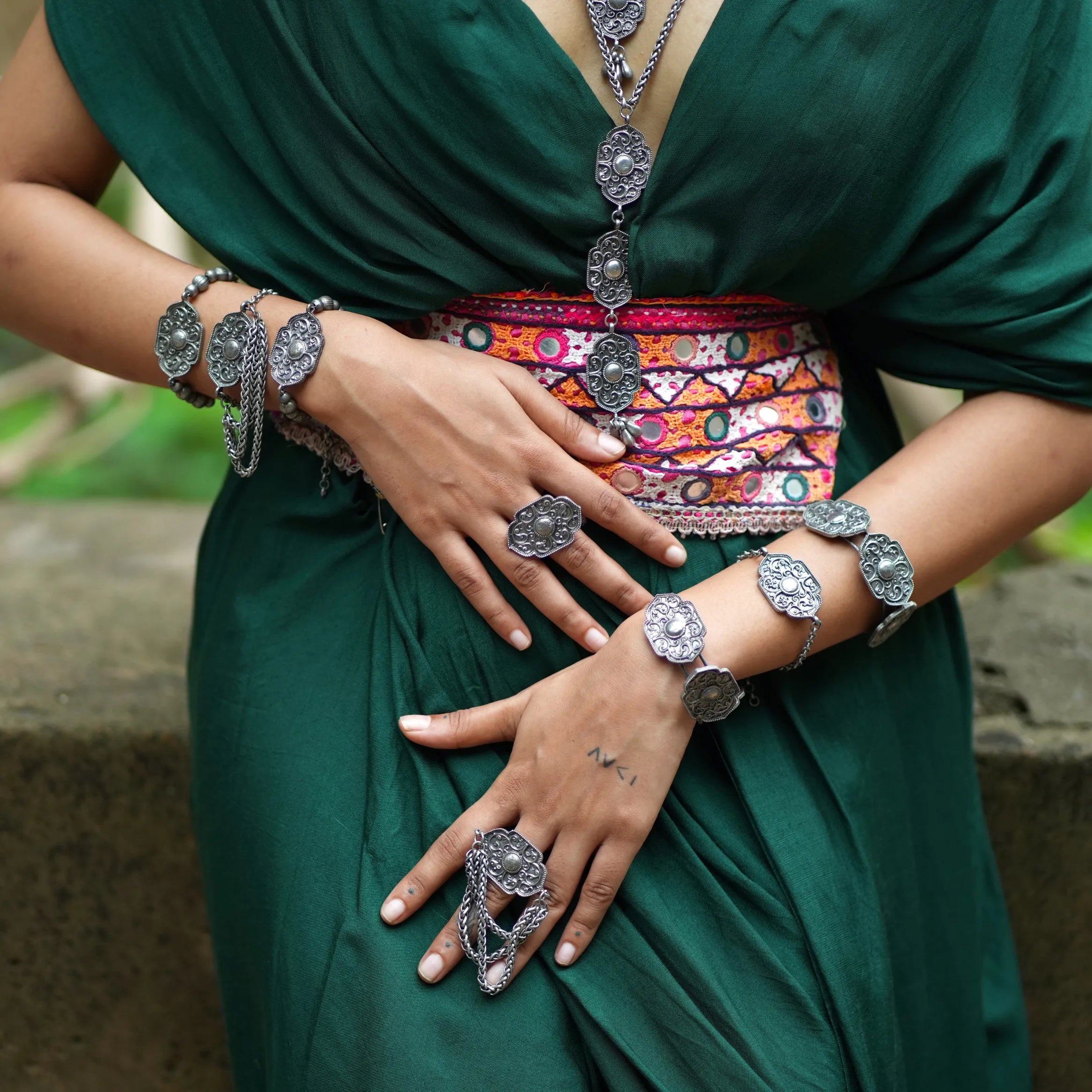 Close-up of Jalakriti oxidised brass tribal bracelet with chain detailing and matching statement ring – Complimento handmade jewelry.
